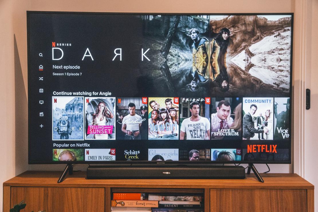 black flat screen tv turned on displaying man in black suit